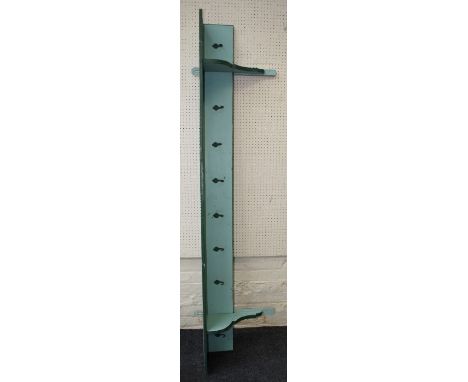 An early 20th century continental painted pine shelf/coat rack, the plank top on shaped end supports fitted eight steel hooks