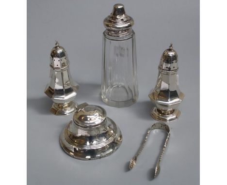 A pair of pepper shakers, inkwell, sugar tongs and silver lidded glass sugar castor, gross weight of metal 238g, 7.65 troy oz