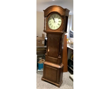 W Walters of Ashbourne 8 day longcase clock with round dial contain in a oak case with turned columns to the trunk and hood s