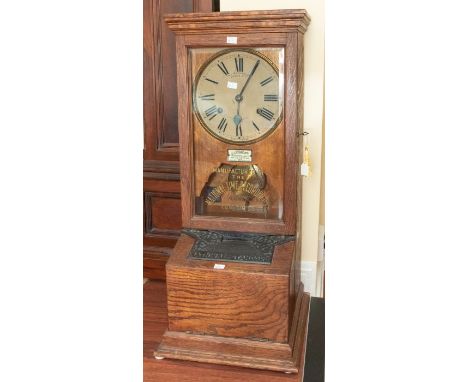 A rare desk or wall-mounted autograph time recorder/ clocking-in clock by 'Time Recorders Leeds Ltd' in an oak case, 15" x 35