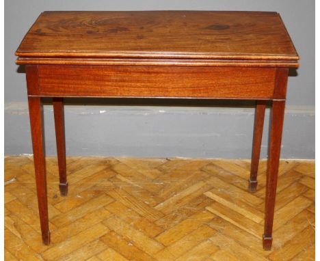 A George III mahogany card table, the oblong top raised on square section legs, W115cm