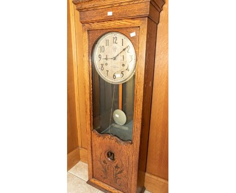 An unrestored International Time Recorder Co Industrial wall-mounted time recorder clocking-on clock. In oak case, 16" x 48" 