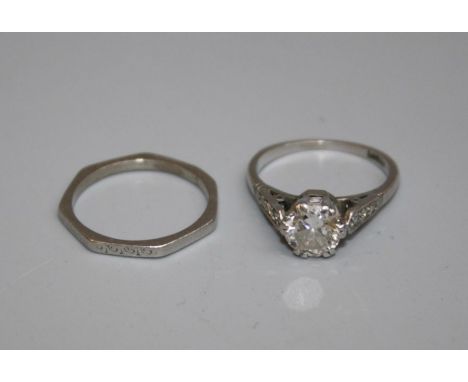 A pair of platinum rings, one on angular band, weighing approx 2.5g, size K, the other an Art Deco style diamond solitaire, c