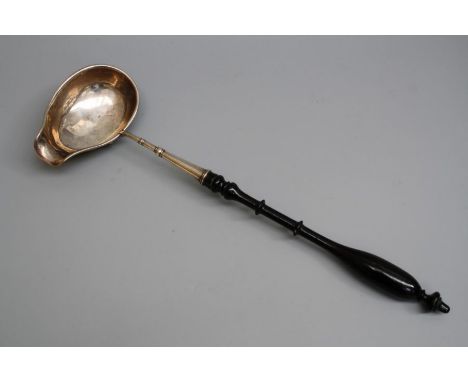 Carl Neuendorf, a 19th century Swedish silver soup ladle, with turned ebonised handle, 44cm