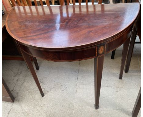 A 19th century mahogany card table with a crossbanded fold over top with a baize interior on square tapering legs