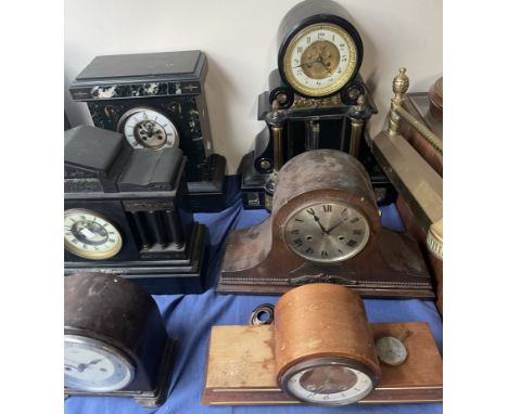 A black slate mantle clock, with a circular dial and mercury pendulum together with a collection of slate and wooden clocks a