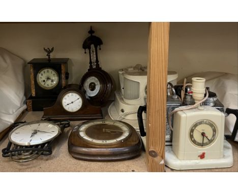 A black slate mantle clock together with three other clocks, a barometer and two teasmaids
