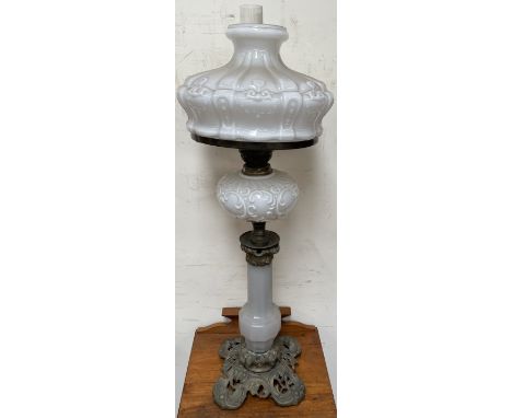 A Victorian oil lamp with an opaque glass shade and similar reservoir on a panelled baluster column and gilt metal base  COND