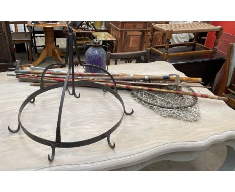 A wrought iron hanging hooks of circular form together with a lantern and fishing rod parts and nets 