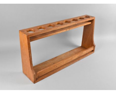 A Modern Wooden Spice Rack with Eight Circular Recesses and Open Base, 58cms Wide 