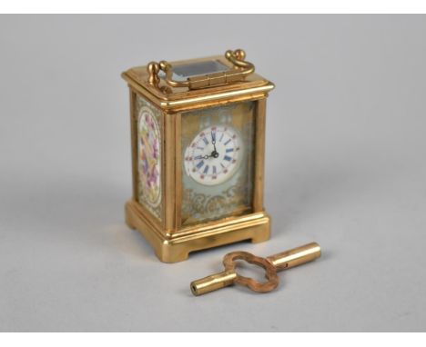 A Reproduction Miniature Gilt Brass and Sevres Style Porcelain Panel Carriage Clock, With Key and Working 