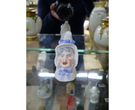 A Royal Worcester candle snuffer figure of 'Mrs Candle', circa 1899, 7cm high. 