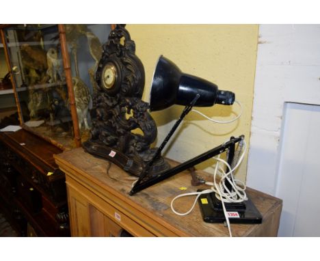 A black painted anglepoise lamp.