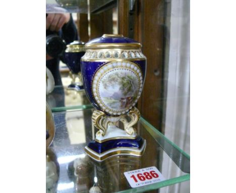 A Grainger & Co Worcester pot-pourri vase and cover, painted with an oval panel of cattle watering, on three scroll legs with