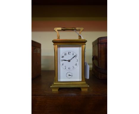 A good gilt brass carriage clock, with bell striking alarm, height including handle 15.5cm.