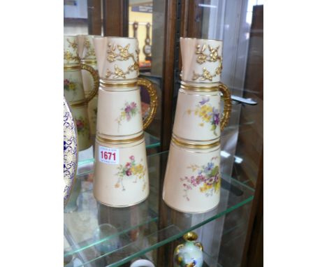 A pair of Royal Worcester blush ivory ewers, circa 1907/8, painted with floral sprays, 23cm high. 