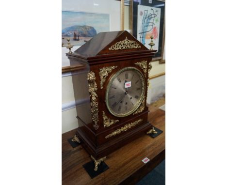 A walnut and gilt brass mounted musical mantel clock, the three train movement striking on eight bells, 54cm high. 