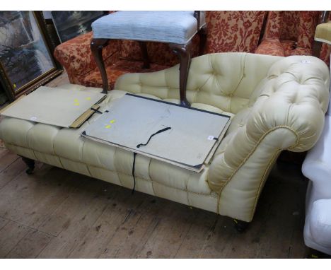A Victorian walnut and button upholstered chaise longue.
