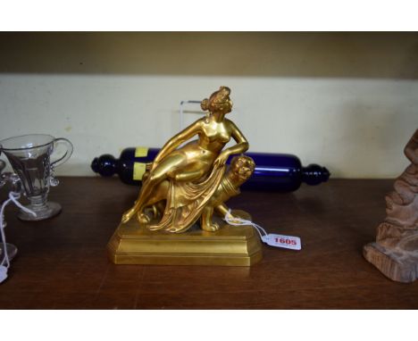 A gilt bronze or brass figure of a classical figure on a lioness, 15.5cm wide. 