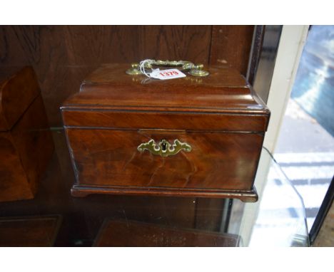 A George III mahogany tea caddy, the hinged top enclosing a divided interior with three further covers, 24.5cm wide. 