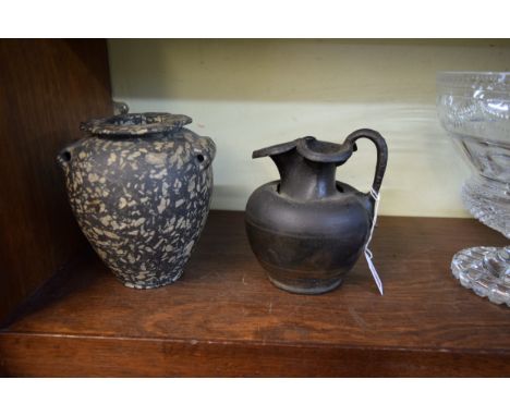 Antiquities: a Roman bronze jug, 15.5cm high; together with an antique twin handled vase, 16cm high.  Condition Report: These