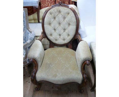 A Victorian carved walnut and button upholstered occasional armchair. 