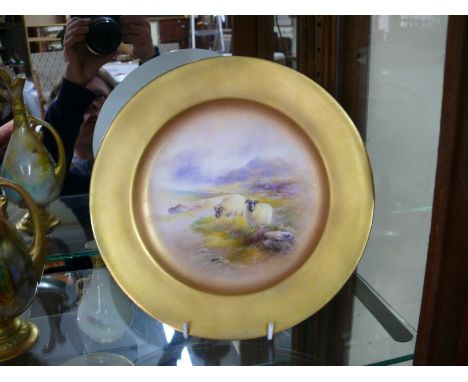 A Royal Worcester cabinet plate, circa 1916, painted with two sheep in a highland landscape by Harry Davis, 23cm diameter.  C