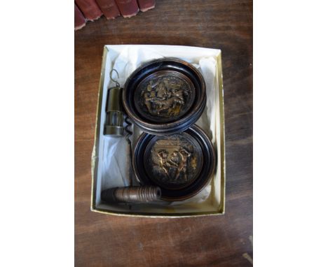 A pair of bronzed metal circular relief plaques, 6.5cm diameter; together with an antique corkscrew; and a brass miniature mi