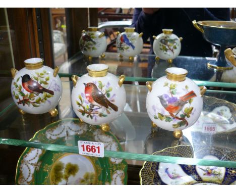 A set of three Victorian Royal Worcester twin handled ovoid tripod vases, each painted with a bird, 8cm high, (possible resto