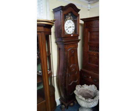 An 18th century French walnut longcase clock, with enamelled circular dial and bombe case, 205cm high, with weights. Conditio