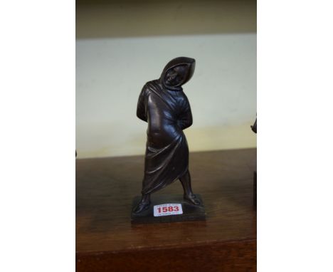 A bronze cloaked figure, the base inscribed Musee de Naples, 17cm high.