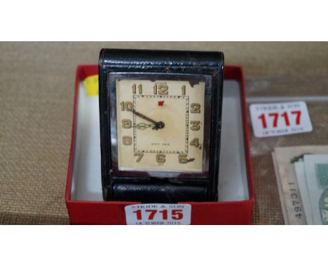 A vintage LeCoultre travelling clock, with folding leather case.