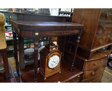 A Regency mahogany and ebonized card table, on turned legs, 91.5cm wide. 