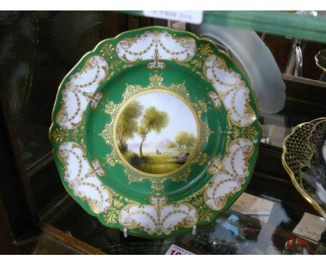 A pair of Royal Worcester cabinet plates, circa 1910, each painted with figures in a landscape, by Harry Davis, within an app