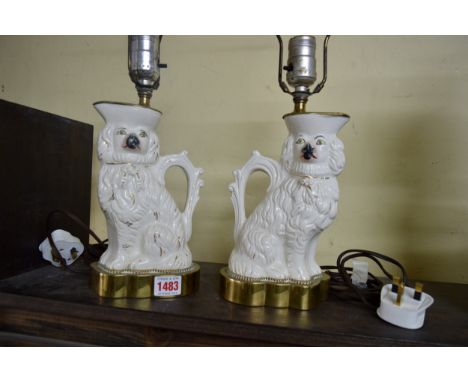 A pair of Staffordshire pottery lamp bases, each modelled as a spaniel jug, with later fitted brass mounts. Condition Report: