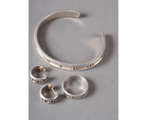 A suite of silver Jewellery, stamped Tiffany &amp; Co, comprising a cuff bangle, ring and earrings, all decorated Roman numer