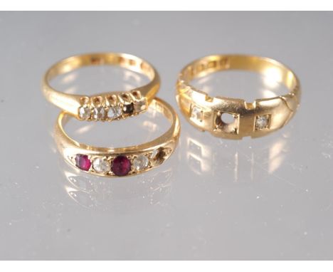 An 18ct gold and diamond five-stone dress ring, size L/M, 2.6g, a similar three-stone dress ring, size N, 4.3g, and an 18ct g