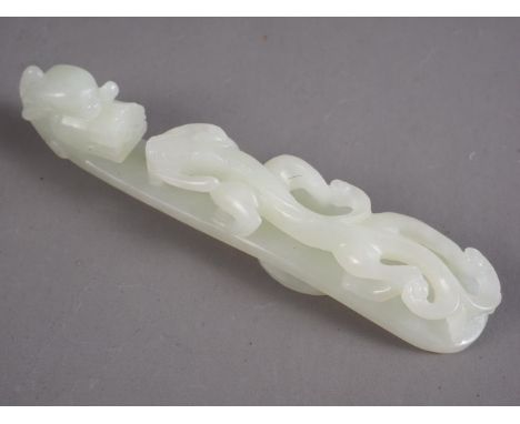 A Chinese carved pale green jade belt loop, formed as a dragon, 4 1/2" longCondition:No visible issues. 