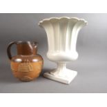 A Doulton Lambeth sprig decorated hunting jug with silver mount, 7" high, and a white glazed campana