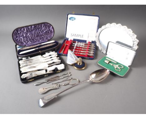A pair of mother-of-pearl and silver plated butter knives, a set of six silver handled cake forks, a set of six silver handle