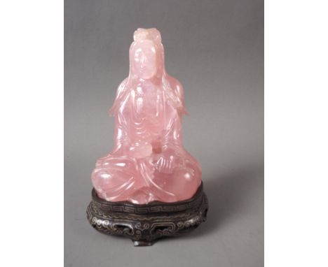 A Chinese rose quartz Buddha (chips to base and edges), on carved and silver inlaid wooden base, 4 3/4" high overallCondition