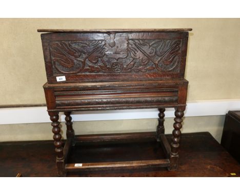 A late 17th century carved oak Bible/lace box, 25" wide x 13" deep x 29" high, on later stand with bobbin turned and stretche