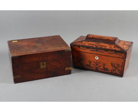 A late 19th century satinwood and rosewood marquetry sarcophagus tea caddy, 12" wide, and a mahogany and brass bound writing 
