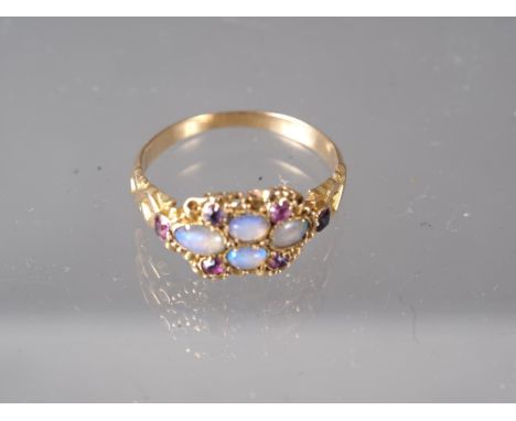 A Victorian yellow metal, opal and ruby dress ring, size L, 1.9gCondition:Ring is slightly misshapen and in need of a good cl