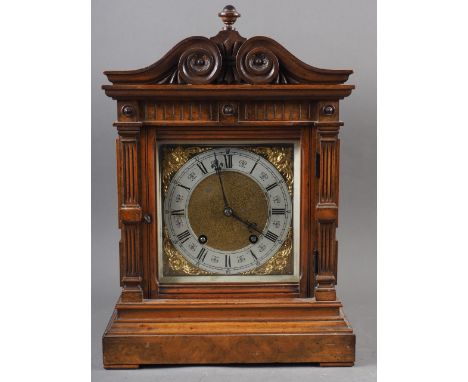 An Edwardian carved walnut cased mantel clock with brass dial and eight-day striking movement 15" high 