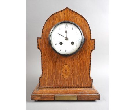 An Edwardian inlaid oak cased mantel clock with white enamel dial and eight-day striking movement, 12 1/2" high, and a&nbsp;s