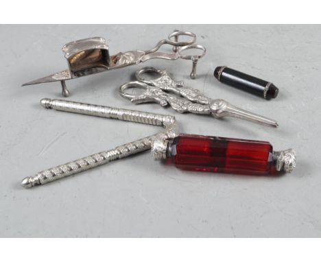 A Victorian white metal and ruby glass double-ended scent bottle, a pair of silver plated grape scissors, a pair of plated wi