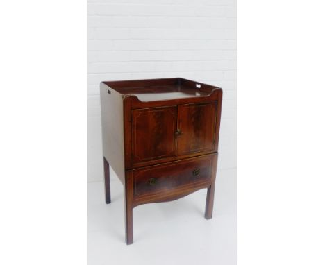A George III mahogany bedside commode with inlaid stringing, with galleried top over a pair of cupboard doors and two long dr