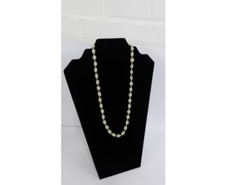 A 15 carat gold and pearl necklace with pearl clusters and gold spacers with a gold clasp fitting