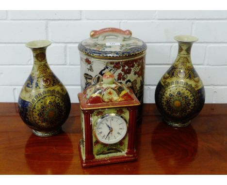A pair of modern Eastern vases together with a storage jar and cover, and a mantle clock, tallest 27cm, (4) 